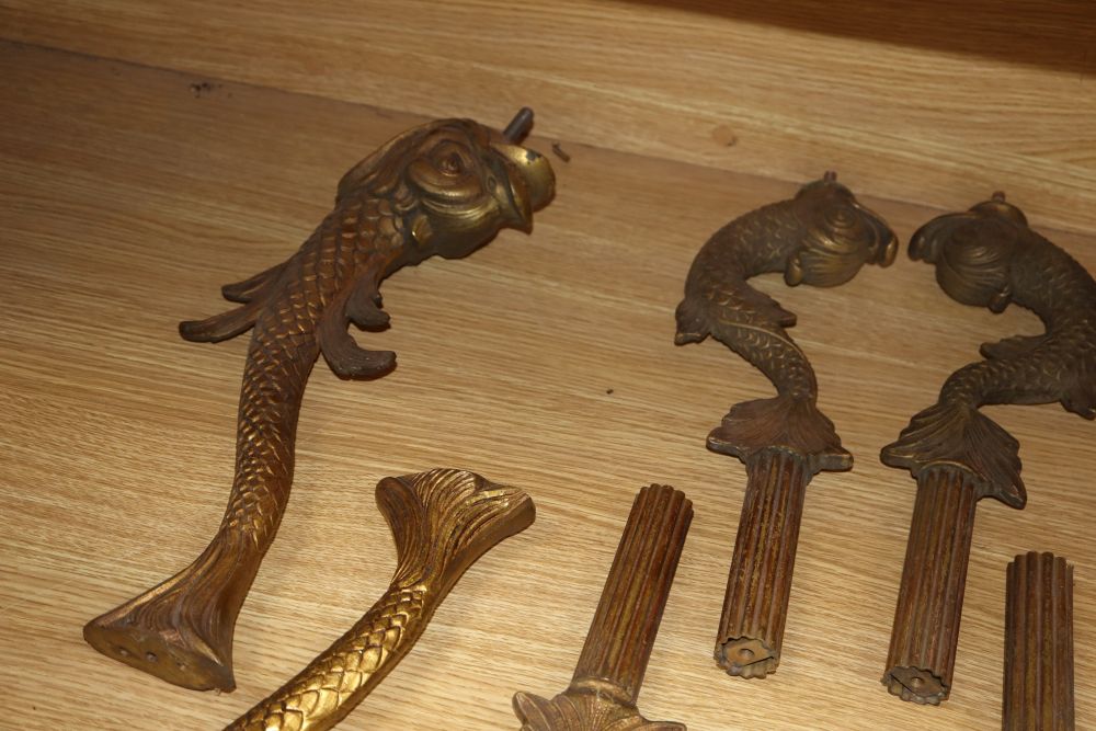 Two sets of four gilt metal dolphin supports, longest excluding screw thread 39cm